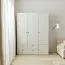 Drehtürenschrank mit integrierter LED-Beleuchtung Aenna 16, zwei Kleiderstangen, Farbe: Weiß / Eiche, Maße: 202,5 x 151 x 60 cm, vier Schubladen, sechs Fächer