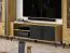 TV-Unterschrank Lassila 06, Farbe: Eiche Artisan / Schwarz - Abmessungen: 54 x 155 x 40 cm (H x B x T), mit zwei Türen und vier Fächern